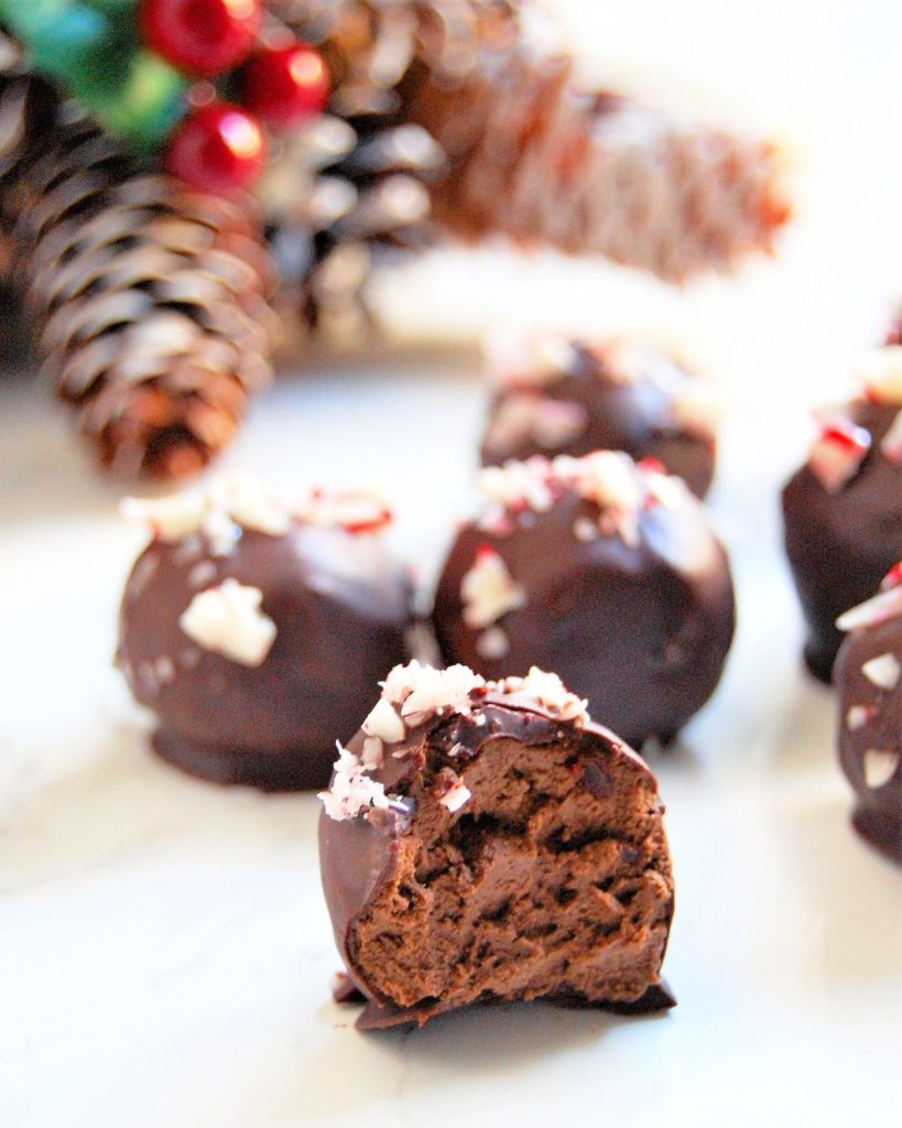 Peppermint Avocado Truffles made with chocolate, avocado, peppermint extract, honey or maple syrup, and candy canes. Very festive and easy candy for the holidays (and works for many kinds of food allergies and sensitivities!)