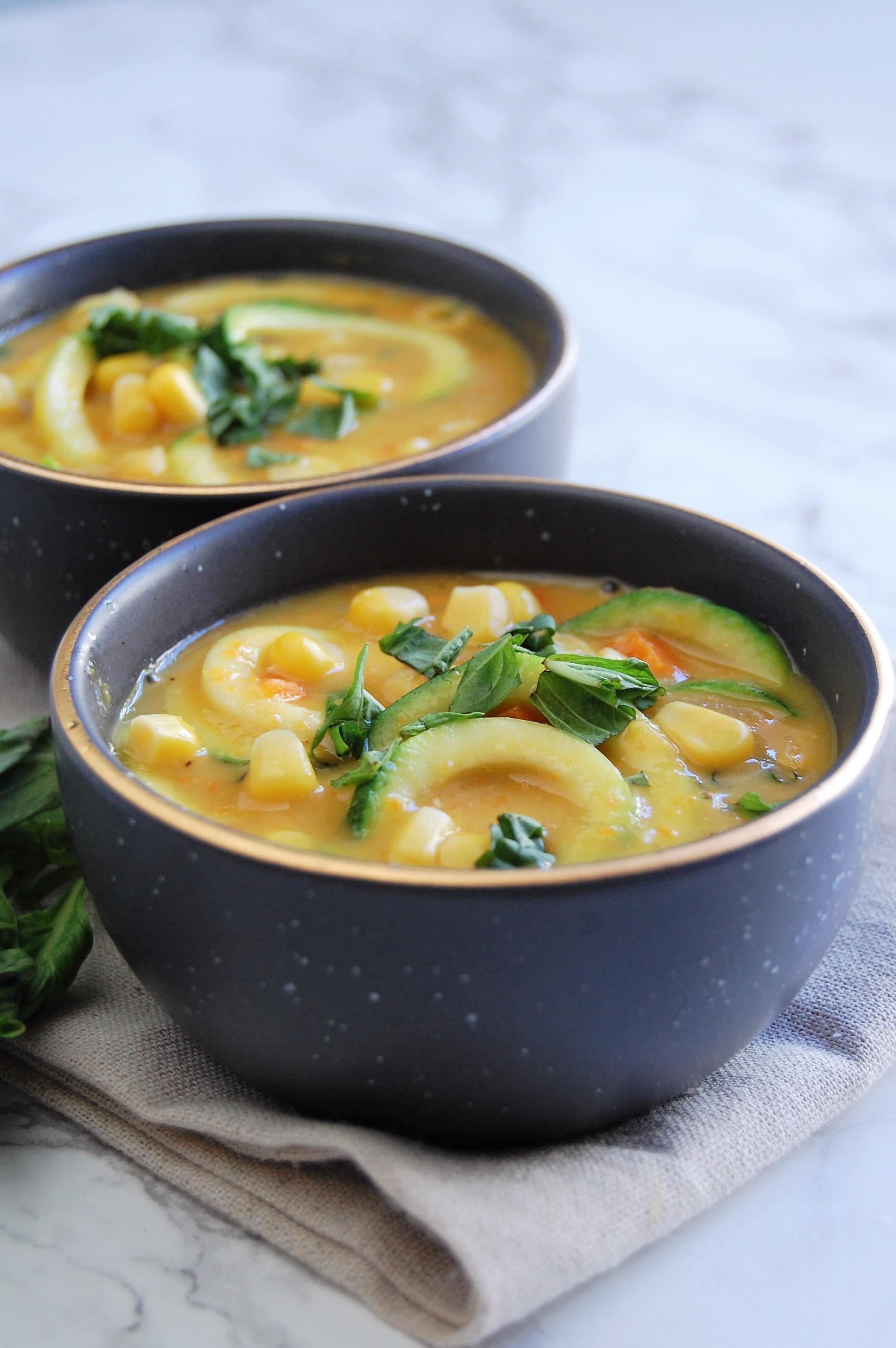 #ad Canned corn is elevated to an on-trend, beautiful and fresh Zucchini Noodle Summer Corn Chowder! IIt's also vegan and free of the top 8 most common food allergens. Get the delicious recipe from @nutritiontofit!