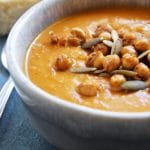 This easy Spiced Sweet Potato Carrot Soup is a delicious, vegan harvest soup. It's packed with flavorful, warm spices and is gluten and dairy-free.Â