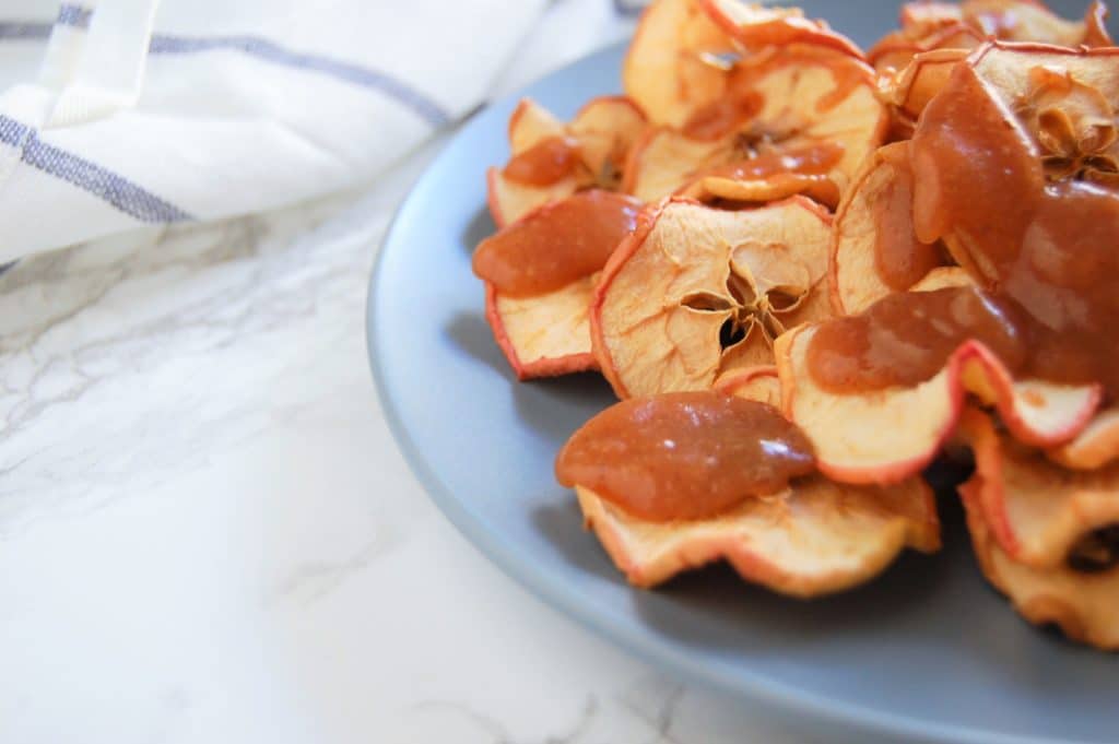 Apple nachos with salted caramel apple butter drizzled over apple chips.