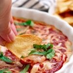 tortilla chip dipping into pizza dip with text that says "Healthy Pizza Dip (delicious, healthy, hummus-based, gluten-free)"