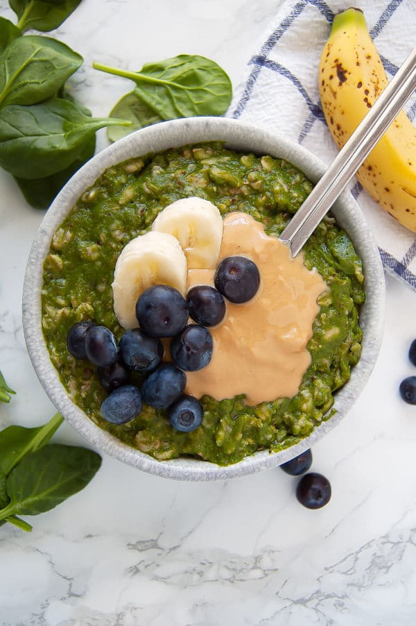 Green Smoothie Oatmeal is the perfect hybrid breakfast when you want both an energizing green smoothie and a cozy warm bowl of oats. This green oatmeal is gluten-free, dairy-free, egg-free, nut-free, and vegan. | Nutrition to Fit
