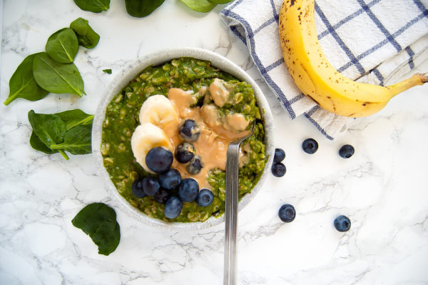 Green Smoothie Oatmeal is the perfect hybrid breakfast when you want both an energizing green smoothie and a cozy warm bowl of oats. This green oatmeal is gluten-free, dairy-free, egg-free, nut-free, and vegan. | Nutrition to Fit