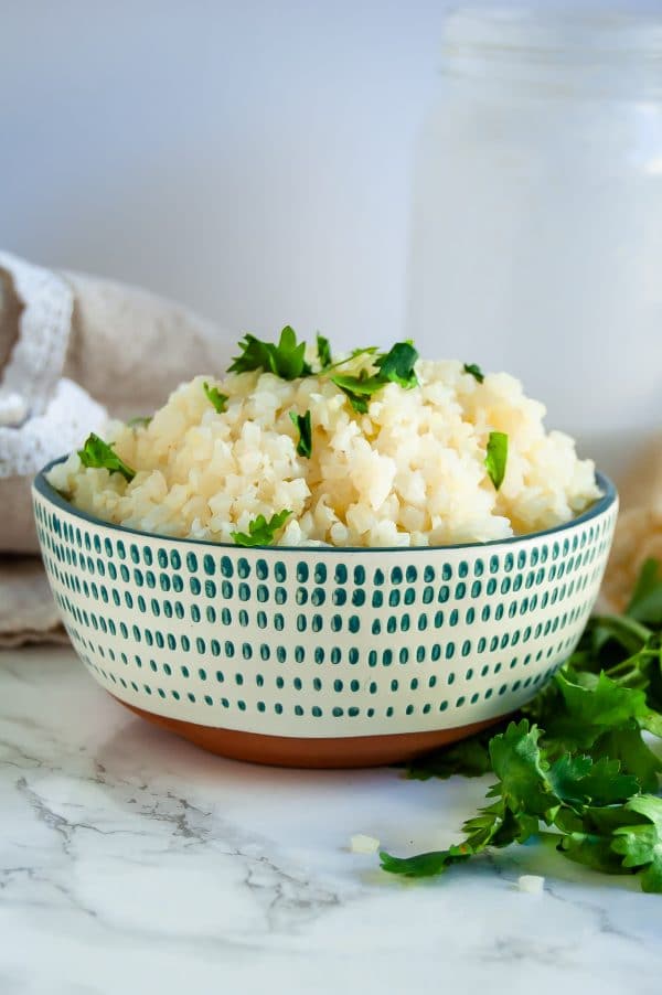 Coconut cauliflower rice is a simple, delicious side that will become a versatile, healthy dinner recipe staple! | #glutenfree #dairyfree #healthydinnerrecipe #cauliflowerrice #vegan #healthyrecipe | nutritiontofit.com