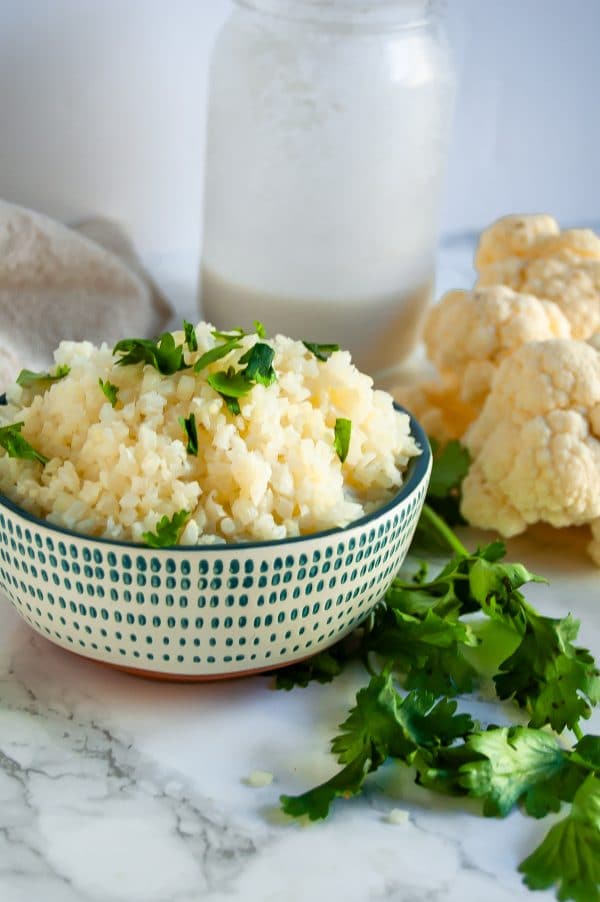 Coconut cauliflower rice is a simple, delicious side that will become a versatile, healthy dinner recipe staple! | #glutenfree #dairyfree #healthydinnerrecipe #cauliflowerrice #vegan #healthyrecipe | nutritiontofit.com