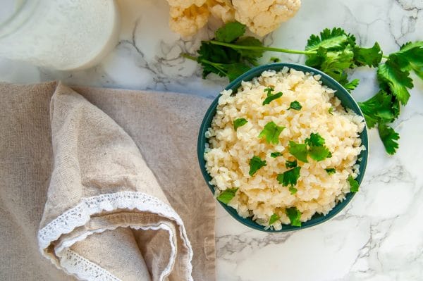 Coconut cauliflower rice is a simple, delicious side that will become a versatile, healthy dinner recipe staple! | #glutenfree #dairyfree #healthydinnerrecipe #cauliflowerrice #vegan #healthyrecipe | nutritiontofit.com