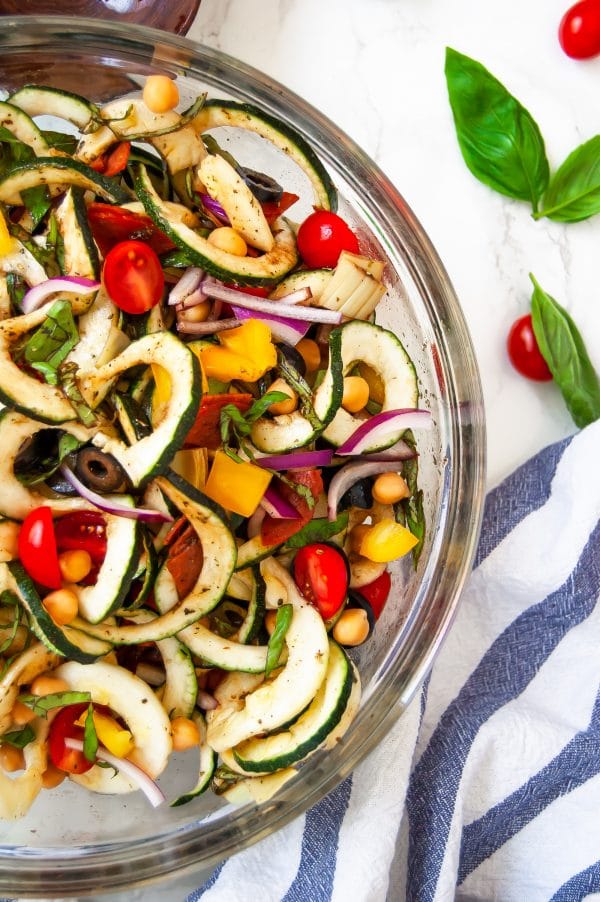 Antipasto salad gets a light and fresh take with this zucchini noodle antipasto salad. A fun zucchini noodle pasta salad, it's perfect with any healthy summer meal.