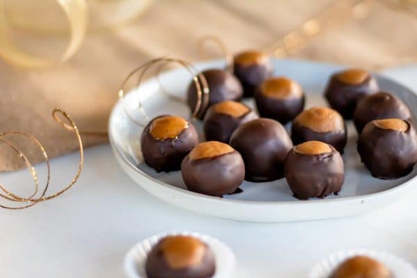 Your favorite peanut butter chocolate treat gets a makeover with this healthy buckeyes recipe, perfect for a healthy holiday dessert or snack!