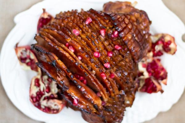 This pomegranate maple glazed ham has a glaze with no refined sugars and a balance of sweet, salty, and a little tang! Perfect for your holiday centerpiece!