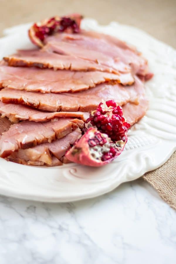 This pomegranate maple glazed ham has a glaze with no refined sugars and a balance of sweet, salty, and a little tang! Perfect for your holiday centerpiece!