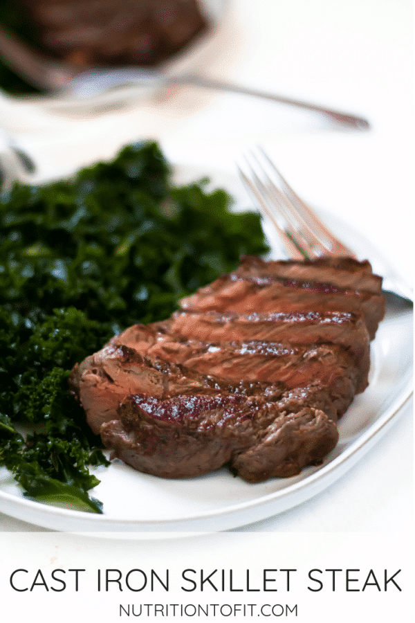 Pinterest Image of sliced cast iron steak on a white plate with massaged kale salad.