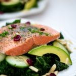 Instant Pot Salmon over a massaged kale salad with avocado, cucumbers, dried cranberries, and almond slivers.