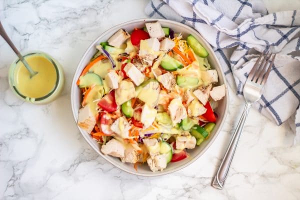 Grilled chicken salad with vegetables on romaine drizzled with healthy homemade honey mustard dressing.