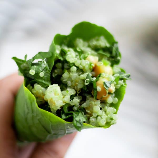 chickpea quinoa salad wrapped in a large turnip green leaf