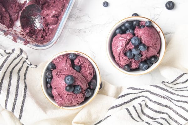 overhead shot of two bowls of blueberry avocado nice cream