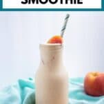 a creamy banana peach smoothie with a teal striped straw and peach garnish