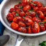 Blistered Tomatoes in a silver skillet