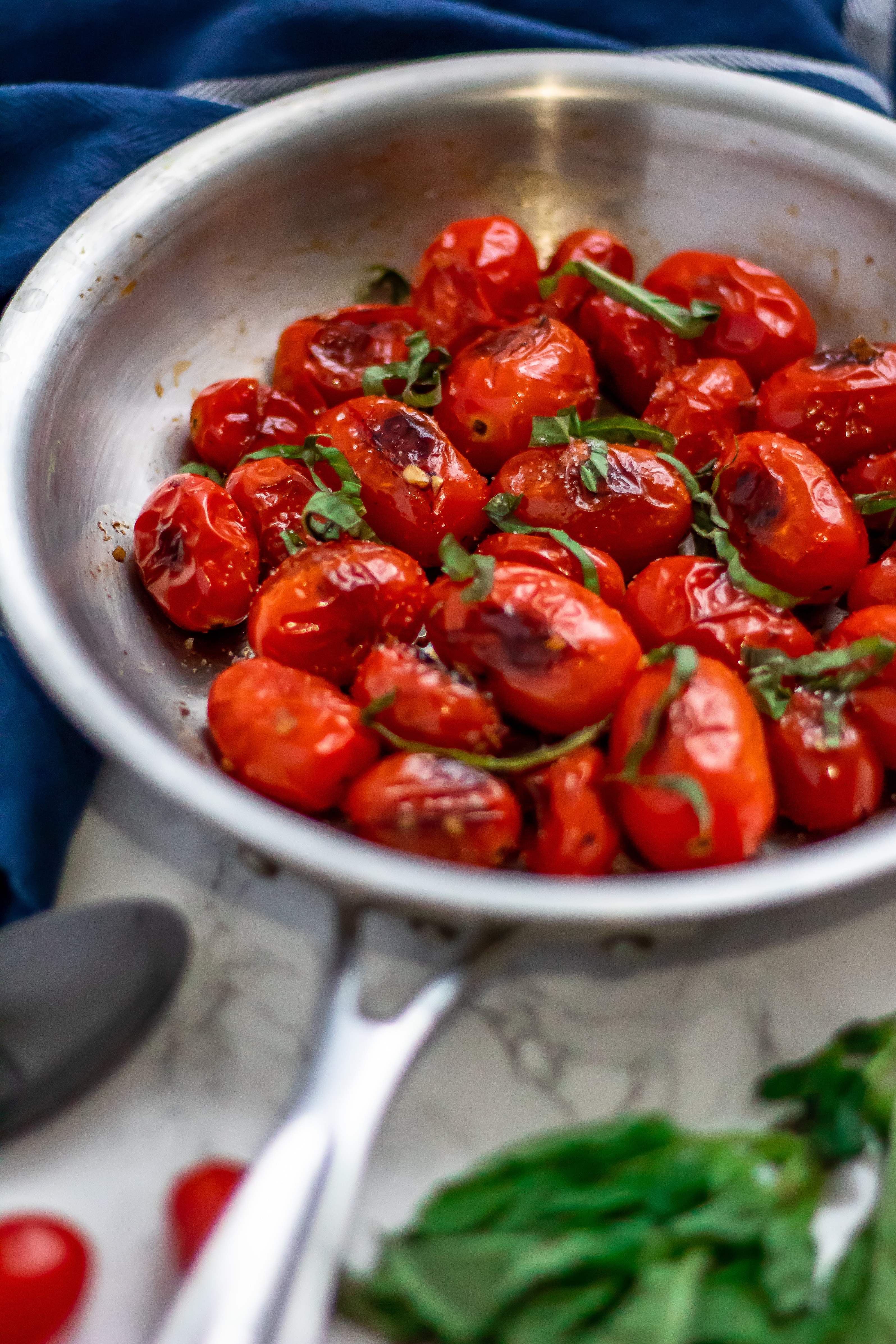 Blistered Tomatoes in a silver skillet