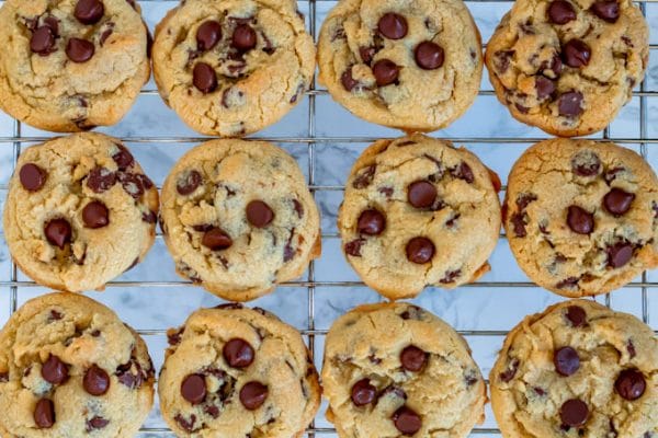 golden brown chocolate chip cookies on a silver wire cooling rack