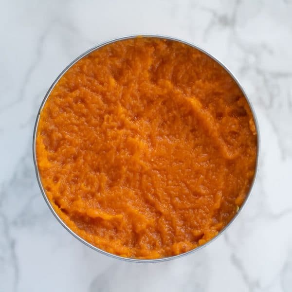 open can of pumpkin puree on a marble background