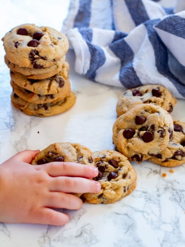 a toddler hand stealing a cookie