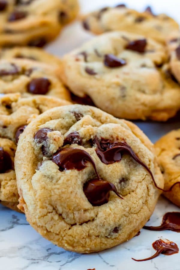 a close up of melty chocolate chips on a gluten free chocolate chip cookie