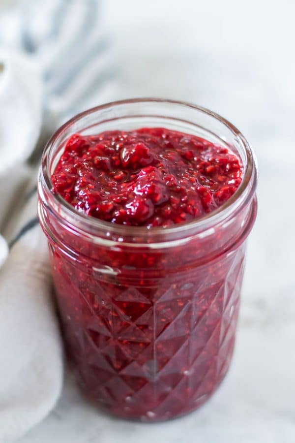 a mason jar of ruby red raspberry chia jam