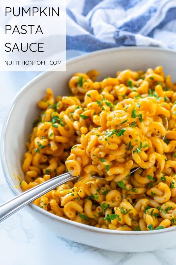 Pinterest image of an ivory shallow bowl of pumpkin sauce coated pasta spirals with text