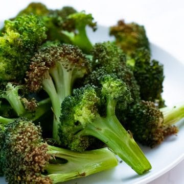 crispy broccoli florets on a white plate