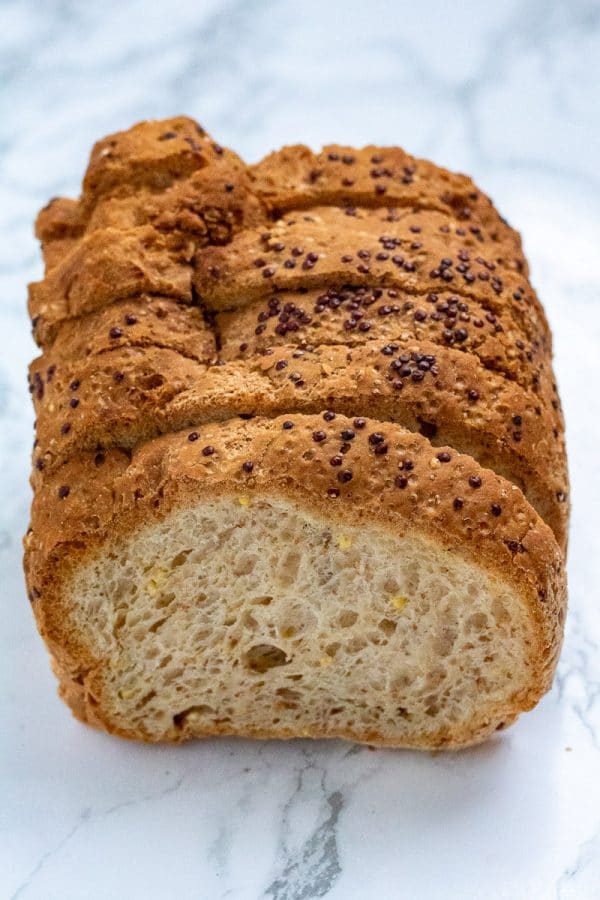 a loaf of whole grain bread on a marble surface