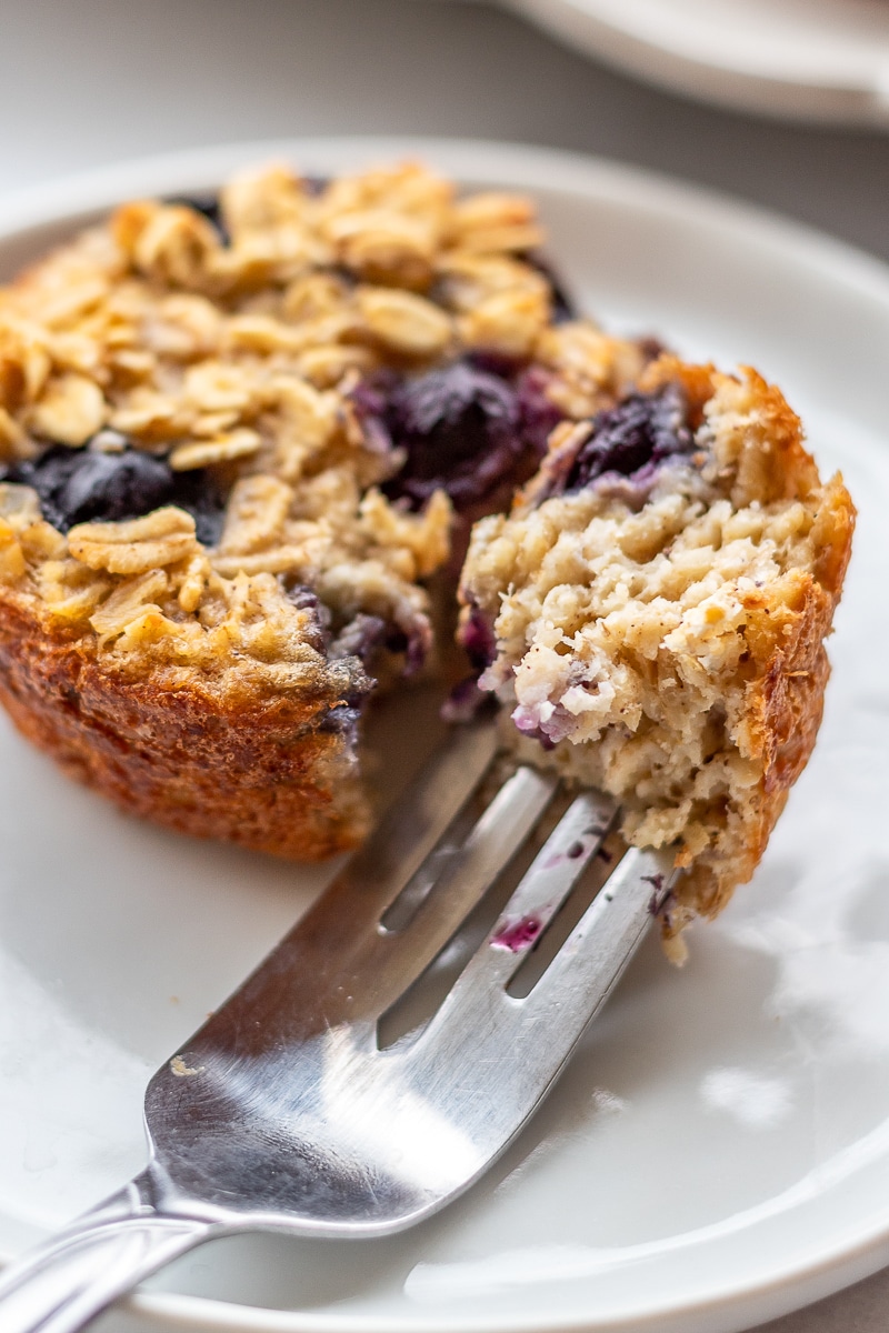 a fork of baked oatmeal cup on a small white plate