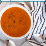 Bowls of dark orange creamy, savory butternut squash soup with text "Savory Butternut Squash Soup"