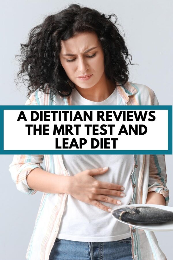 A woman holding her stomach with a text overlay that says, "A dietitian reviews the MRT test and LEAP diet"