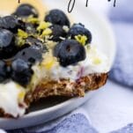 crunchy toast topped with yogurt, blueberries, hemp seeds, lemon zest, with text overlay that reads "blueberry toast"
