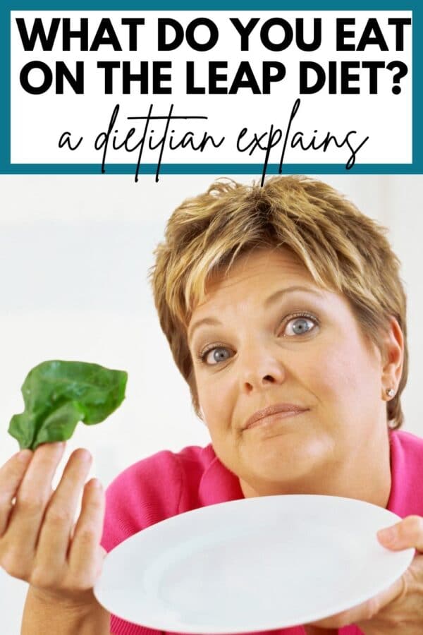 A woman holding an empty plate and a spinach leaf with text that says "What do you eat on the LEAP diet? A dietitian reviews"