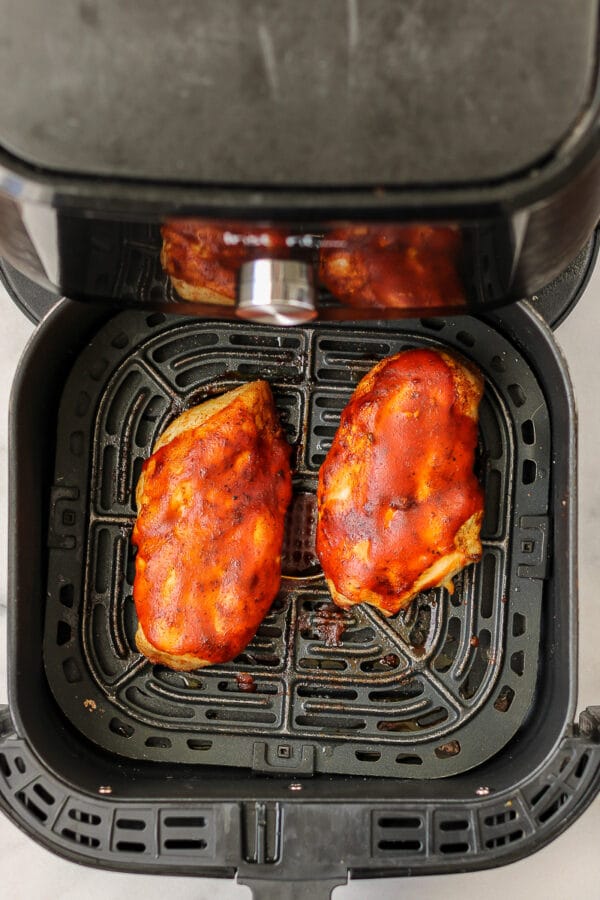 air fryer bbq chicken breasts inside an air fryer basket