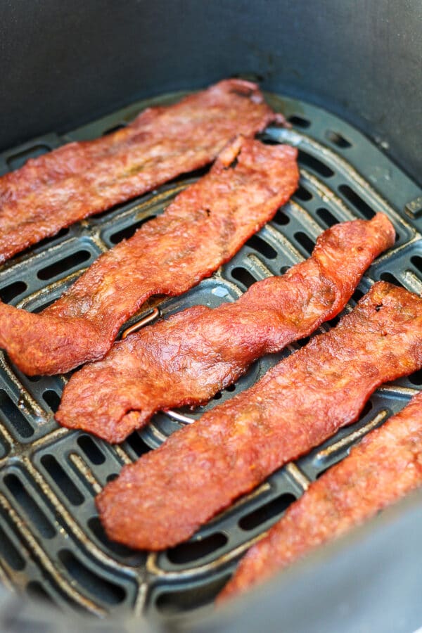 crispy slices of turkey bacon on an air fryer rack