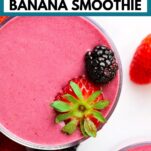 a glass of bright purple pink-colored blackberry strawberry banana smoothie