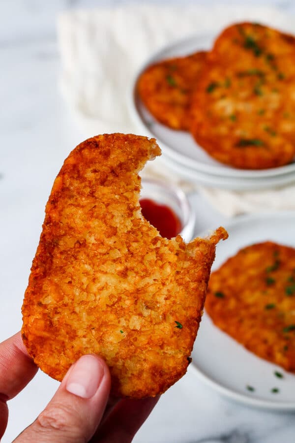 a crispy air fryer hash brown with a bite taken out of it