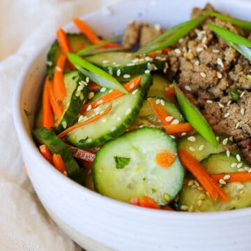 a bowl of carrot and cucumber salad, next to korean ground turkey over rice