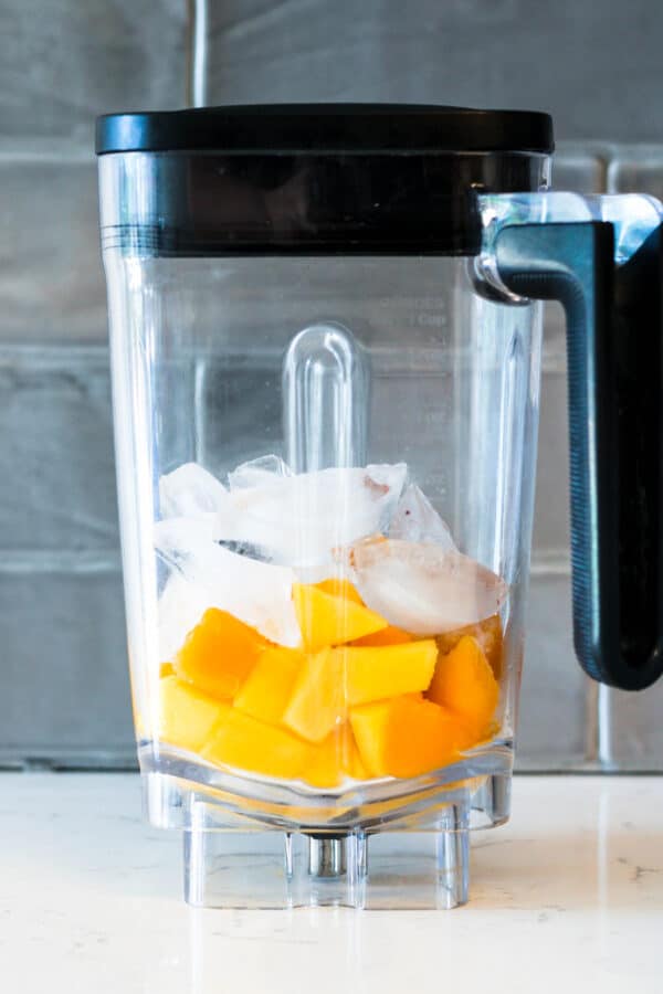 mango and ice in a blender