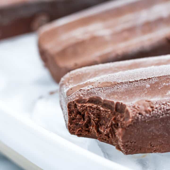 Healthy Chocolate Popsicles with a bite taken out of one
