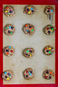 topping gluten free monster cookie dough balls with more m&ms and chocolate chips