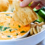 pita dipped into htipiti/ roasted red pepper feta dip