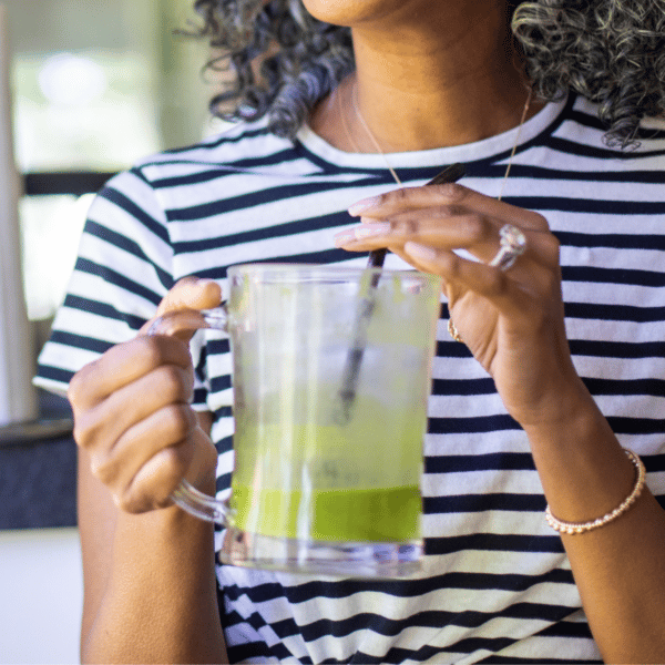 woman drinking a green ka'chava shake