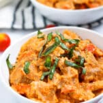 white bowl of creamy ricotta tomato pasta