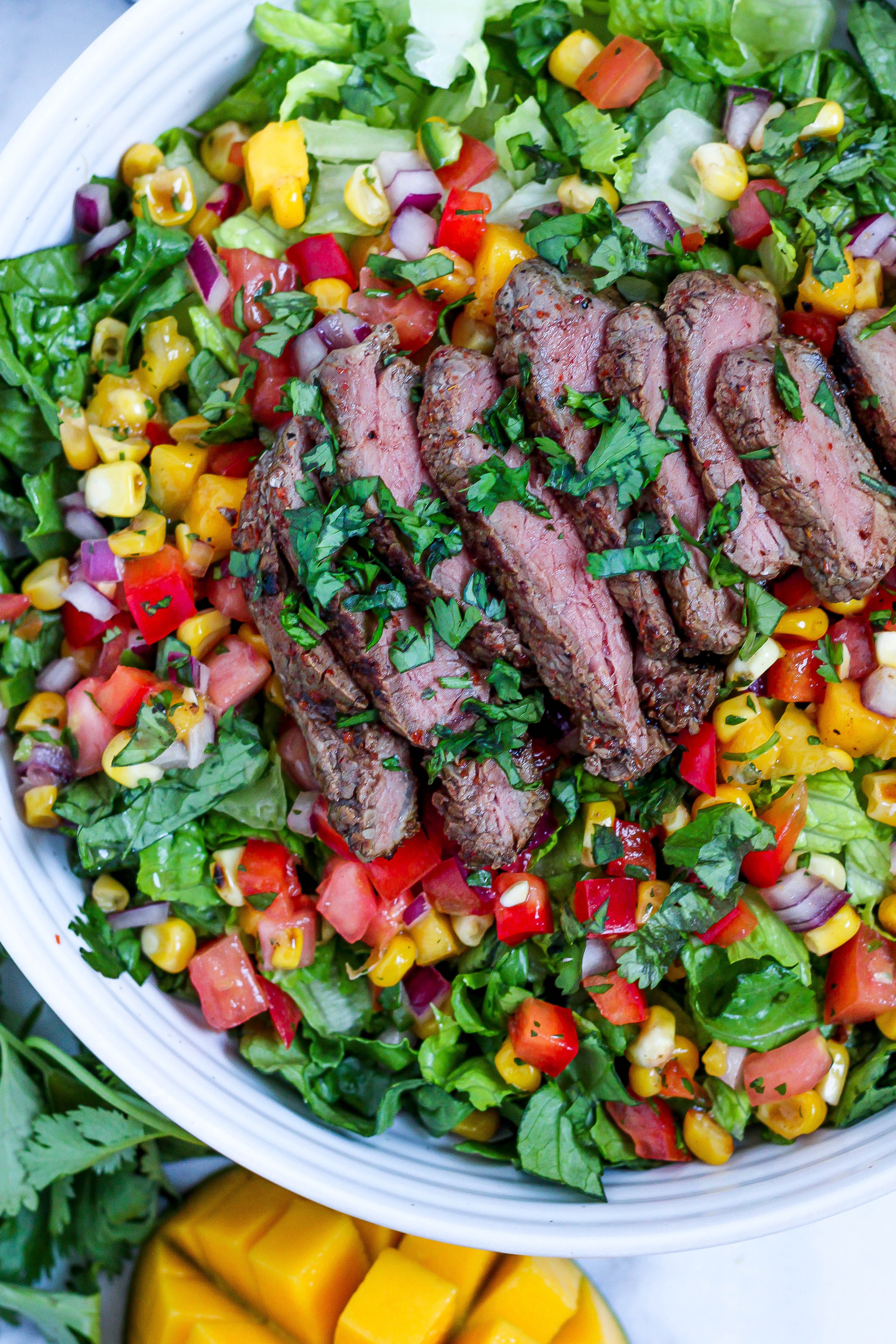 salad with steak and mango corn salsa