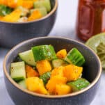 bowl of mango cucumber salad seasoned with tajin
