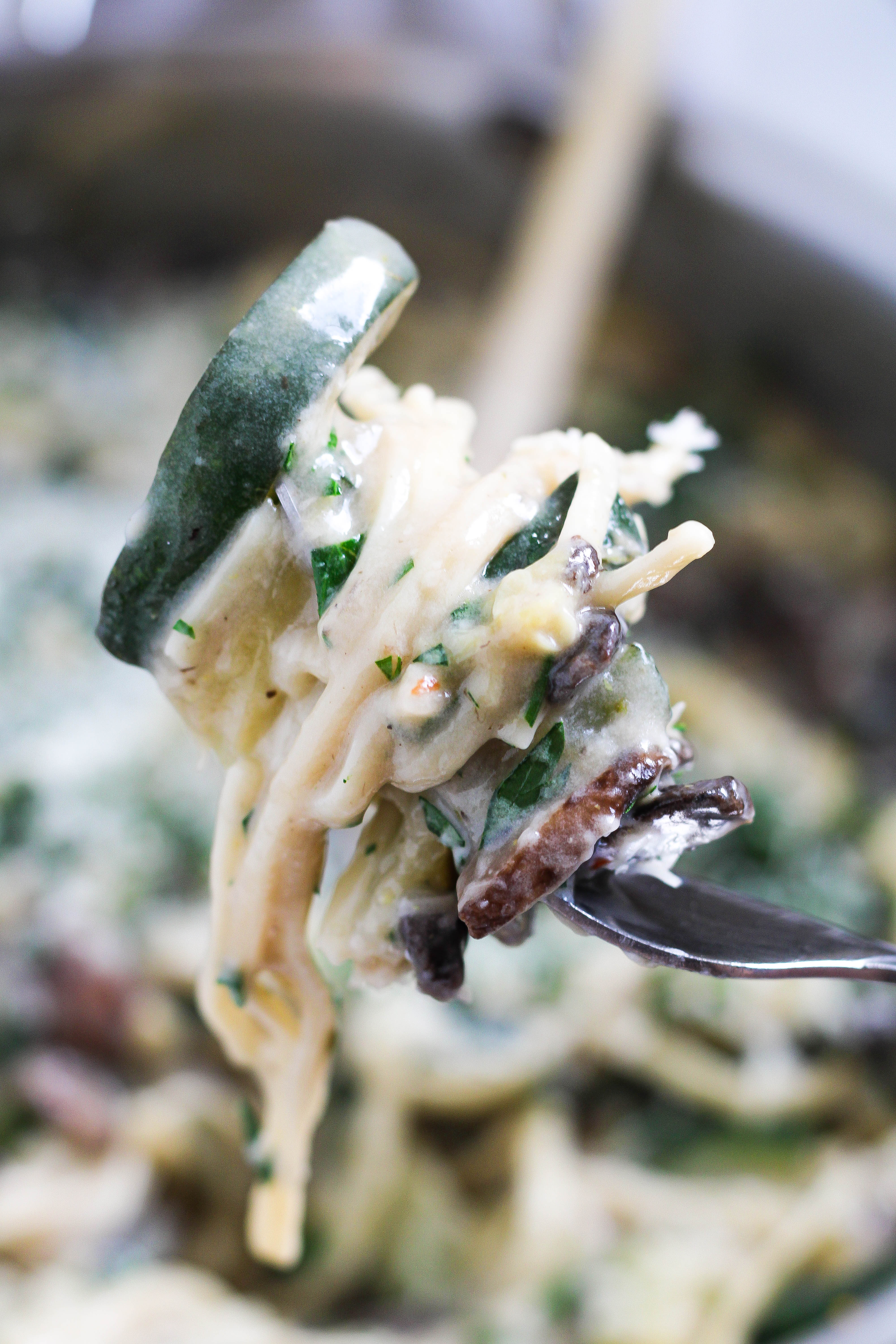forkful of twirled mushroom zucchini pasta