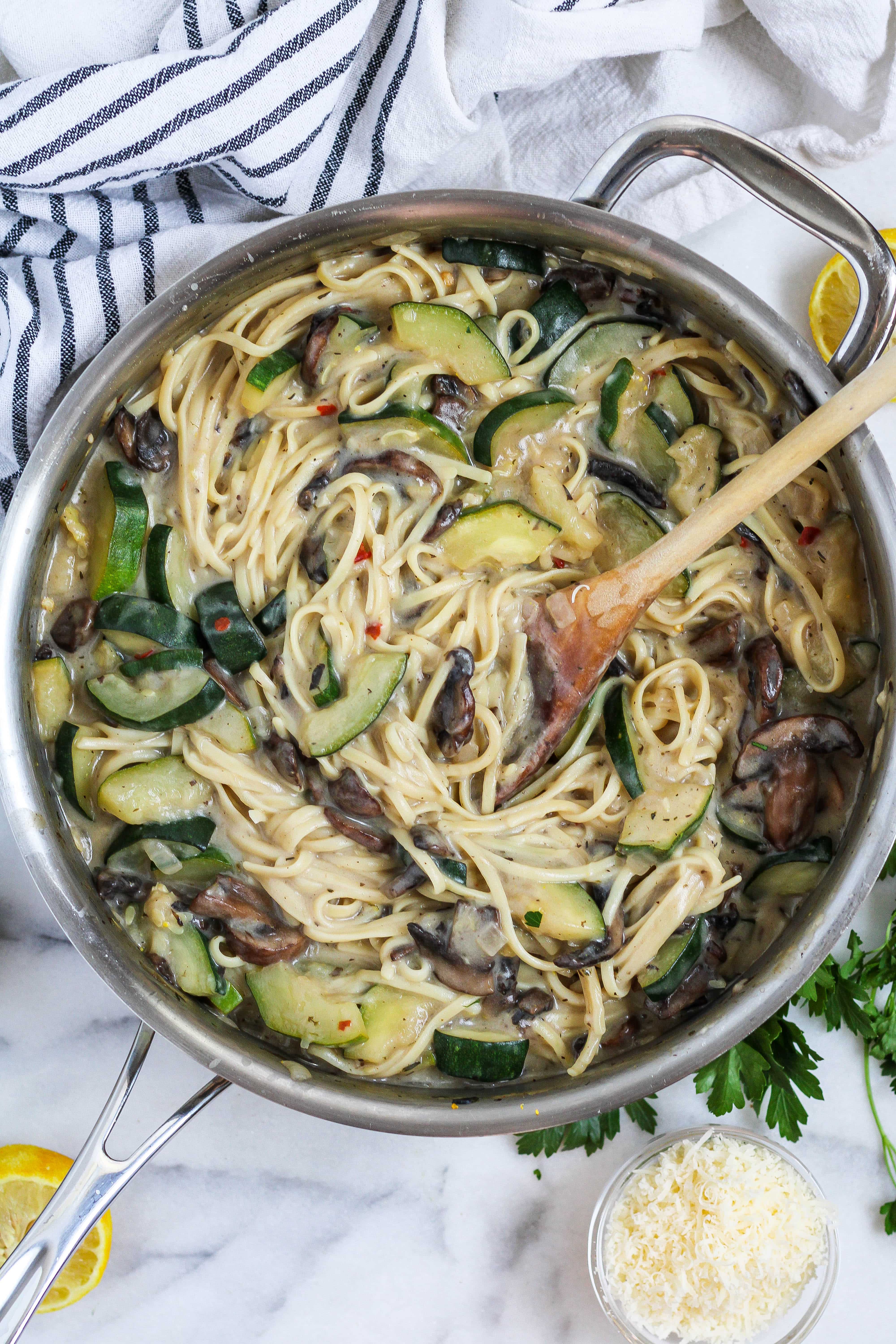 a large pan of creamy mushroom zucchini pasta